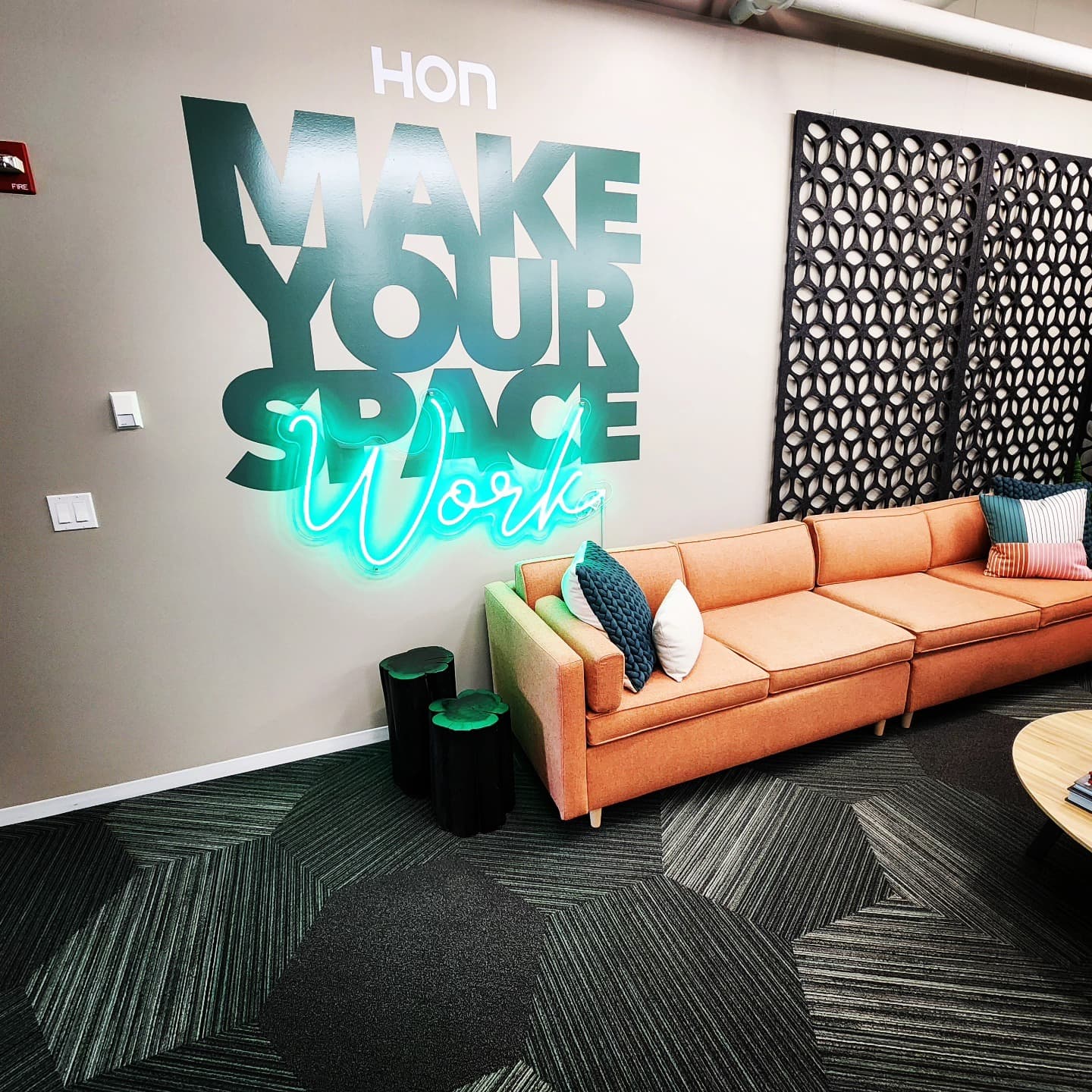 HON Make Your Space Work neon sign with orange sofa