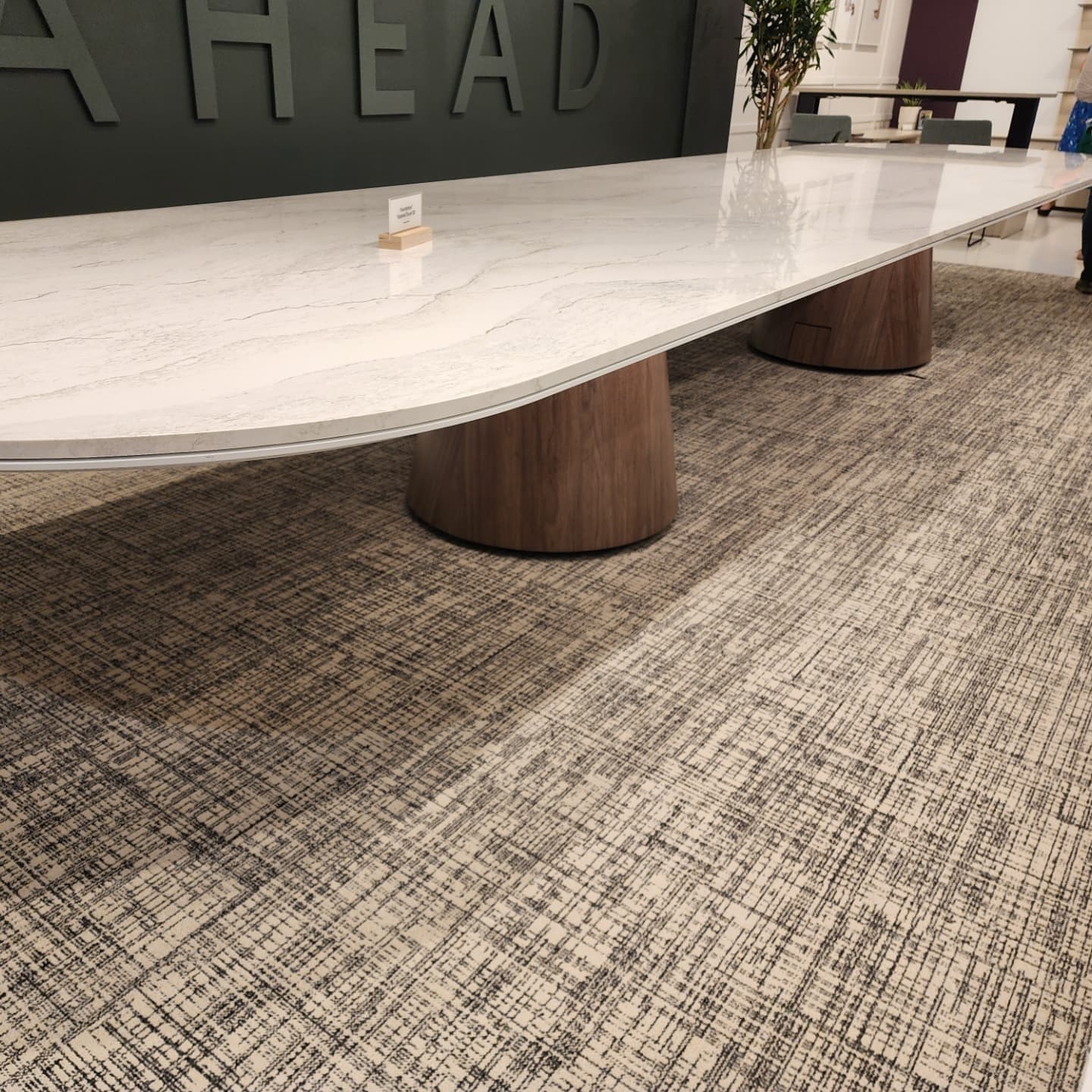 White marble conference table with wood pedestal base