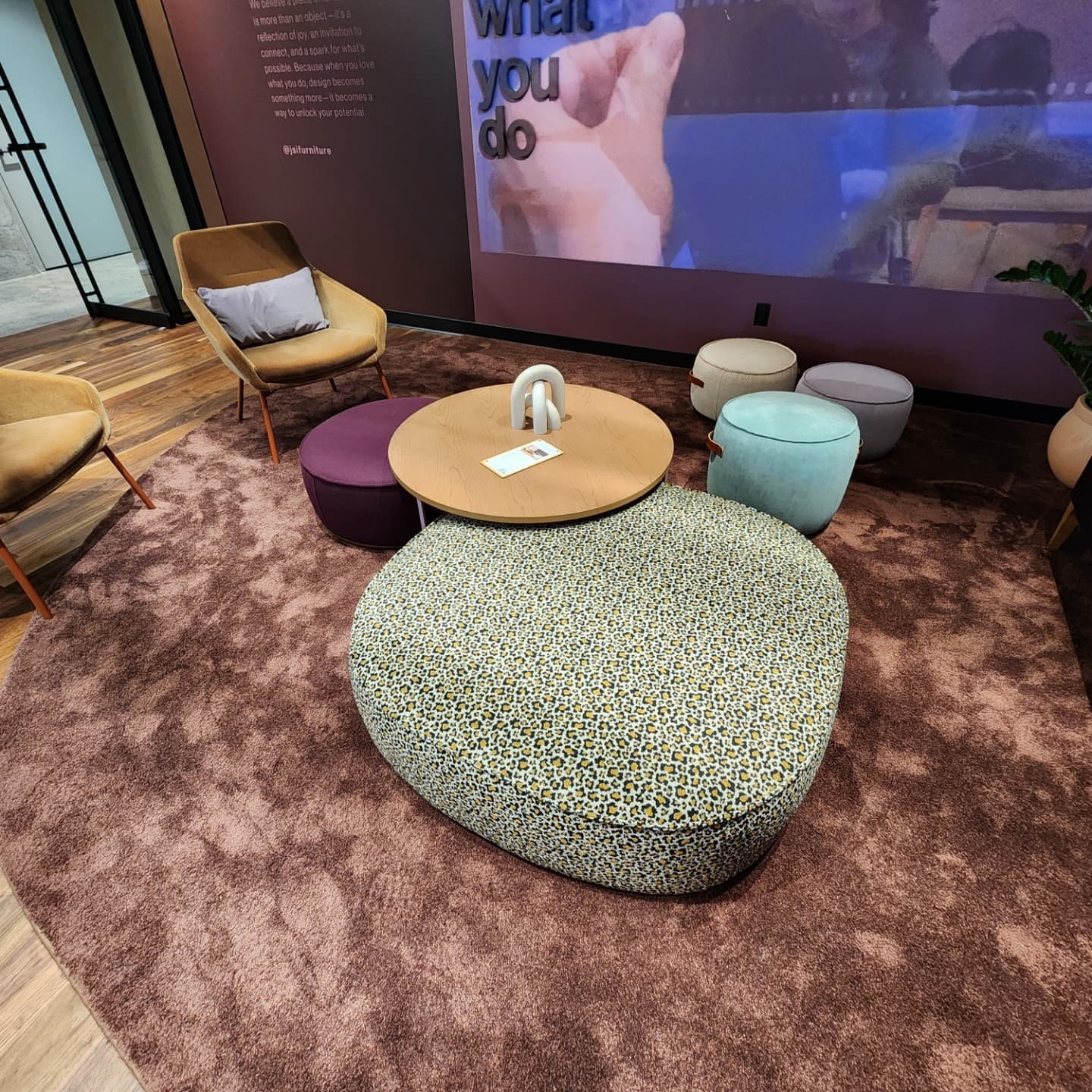 JSI lounge with colorful poufs on plush rug